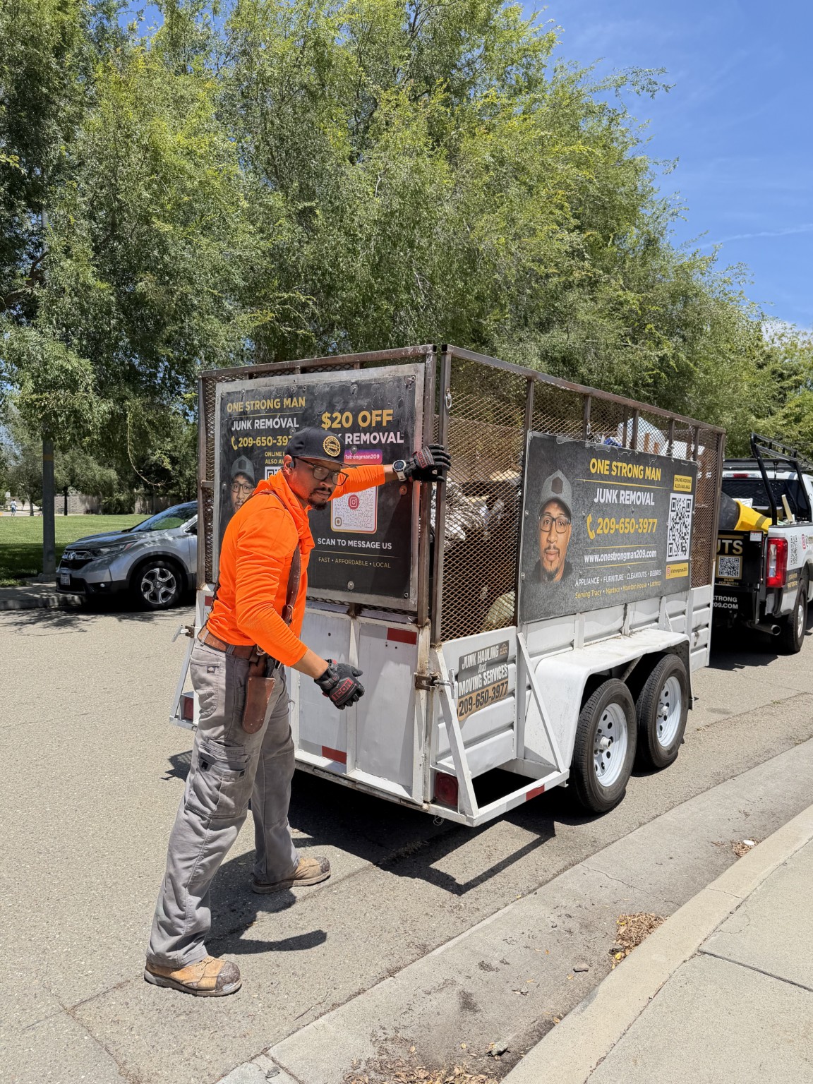 Steward working beside the One Strong Man trailer in the Tracy area